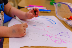 Preschooler coloring with markers
