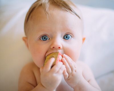 Baby with block in his mouth