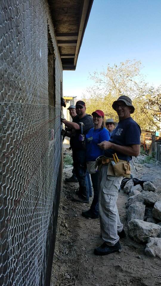 Members of Casas Por Cristos building a house