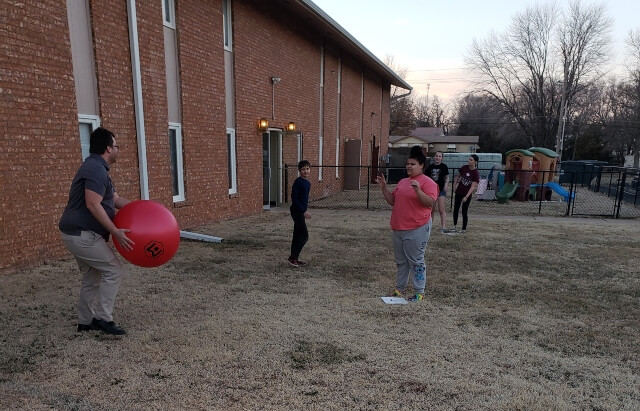 Youth playing kickball